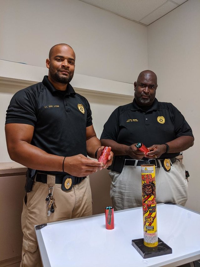 Philadelphia Police Lt. Eric Lyons and Chief Julian Greer examine some of the fireworks that have caused a disturbance in the community.